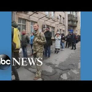 Ukrainians wait in line to buy stamps featuring soldier l ABC News
