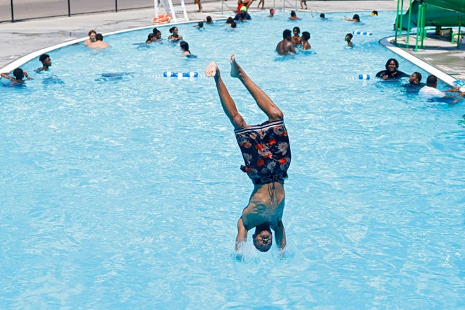 Kenyon Brown dives into the Lacy Park pool in Tulsa, Okla., on July 8, the fifth day in a row with temperatures of 100 degrees Fahrenheit or higher, the first time since July 2012.