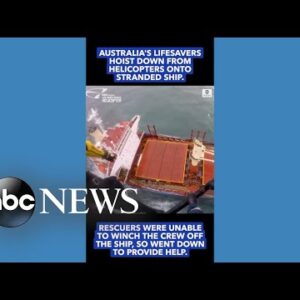 Helicopter lowers rescuers onto stricken ship