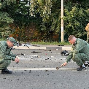 In this photo taken from video released by Russia's Investigative Committee on Sunday, Aug. 21, 2022, investigators work at the scene of the explosion of a car driven by Daria Dugina outside Moscow.