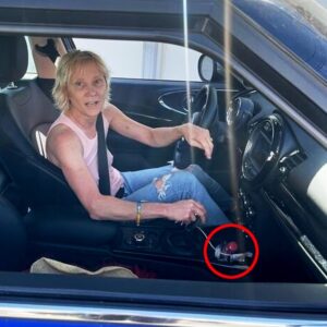 A photo before the Aug. 5 crash shows Heche moments before the second crash behind the wheel with a bottle of vodka in the cup holder