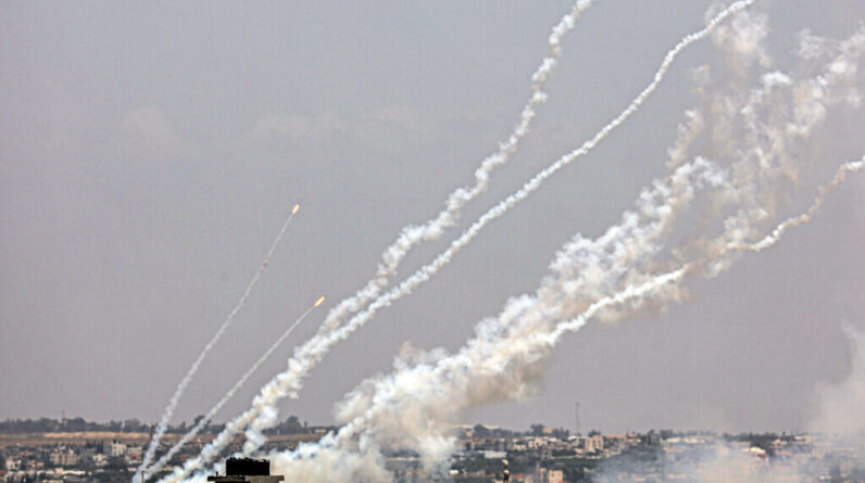 Palestinian terrorists fire rockets from the Gaza Strip toward Israel on May 13, 2023. (Said Khatib/AFP)