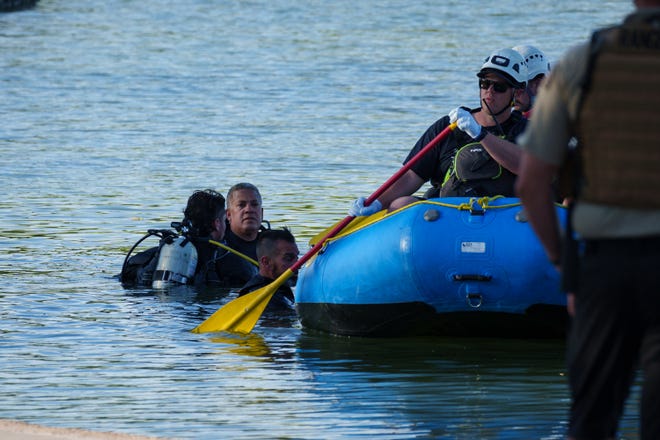 The Maricopa County Sheriff's Office and the Mesa Fire and Medical Department appear to transport a body to the water's edge of the lake at Dobson Ranch Park after a drowning was reported and conducted a water search and rescue operation on May 6, 2023.