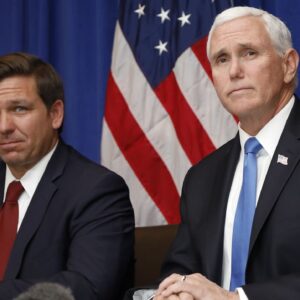 Vice President Mike Pence, right, and Florida Gov. Ron DeSantis take questions during a Florida coronavirus response meeting at the West Palm Beach International Airport on Feb. 28, 2020. (AP Photo/Terry Renna, File)