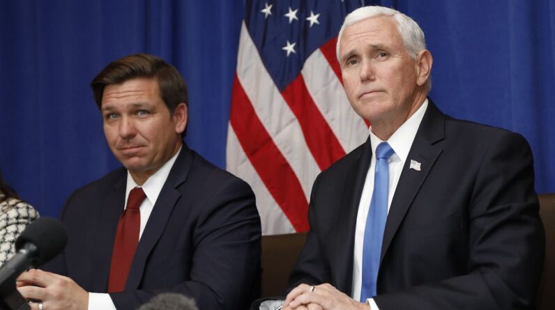 Vice President Mike Pence, right, and Florida Gov. Ron DeSantis take questions during a Florida coronavirus response meeting at the West Palm Beach International Airport on Feb. 28, 2020. (AP Photo/Terry Renna, File)