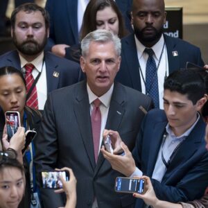 Reporters at the Capitol encircle House Speaker Kevin McCarthy, R-Calif., Thursday as debt limit negotiations continue. (AP Photo/J. Scott Applewhite)