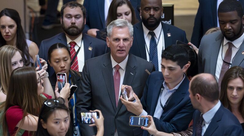 Reporters at the Capitol encircle House Speaker Kevin McCarthy, R-Calif., Thursday as debt limit negotiations continue. (AP Photo/J. Scott Applewhite)