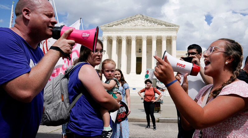 A pro-life activist and a supporter of legal abortion square off with megaphones in front of the U.S. Supreme Court in Washington June 24, 2023, the first anniversary of the court's 2022 ruling in Dobbs v. Jackson Women's Health Organization. (OSV News/Reuters/Evelyn Hockstein)