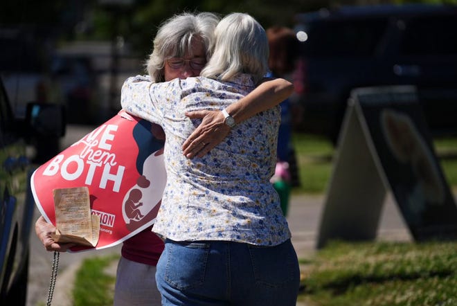 Mari Schoen of Gahanna hugs a fellow supporter as they celebrate the Supreme Court's overturning of Roe v Wade as they stand outside the Planned Parenthood Clinic on East Main Street in Columbus in June 2022.