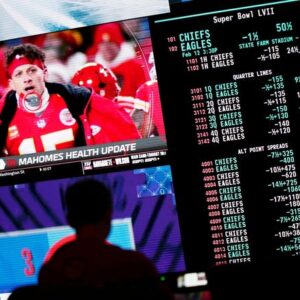 A person gambles as NFL football Super Bowl betting odds are displayed on monitors at the Circa Resort and Casino sportsbook Friday, Feb. 3, 2023, in Las Vegas.