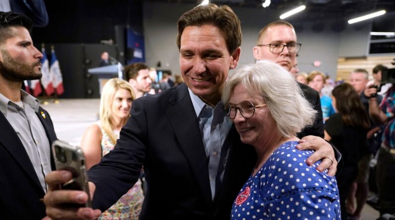 Republican presidential candidate Florida Gov. Ron DeSantis poses for a photo with Bette Guzman, of West Des Moines, Iowa, during a campaign event, May 30, 2023, in Clive, Iowa. As DeSantis embarked on the first official week of his presidential candidacy, the Florida governor repeatedly hit his chief rival, Donald Trump, from the right.(AP Photo/Charlie Neibergall, File)