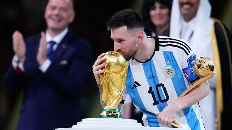 Argentina's Lionel Messi kisses the World Cup trophy after receiving the Golden Ball award for best player of the tournament during the awards ceremony after Argentina defeated France in the World Cup final soccer match at the Lusail Stadium in Lusail, Qatar, Sunday, Dec. 18, 2022. (AP Photo/Natacha Pisarenko)